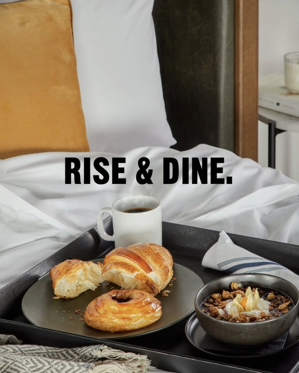 Breakfast tray with croissants, pastry and coffee served on a Broadview Hotel bed — Rise & Dine